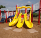 Three children going down slide with Gouglerville foam mats at the bottom