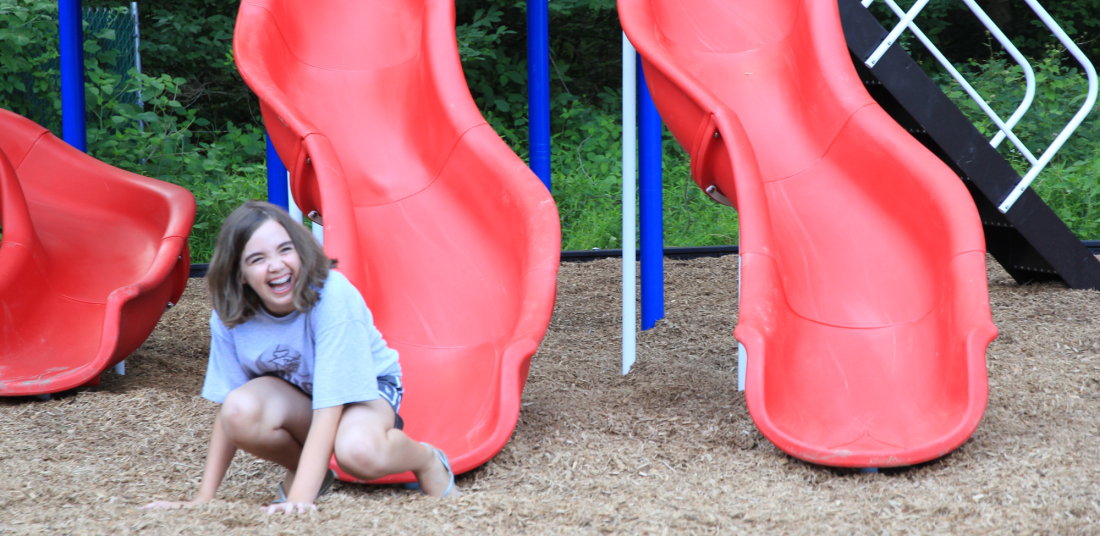 girl sliding down slide at vangelli park