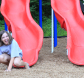 girl sliding down slide at vangelli park