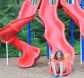 child sliding down a slide at vangelli park